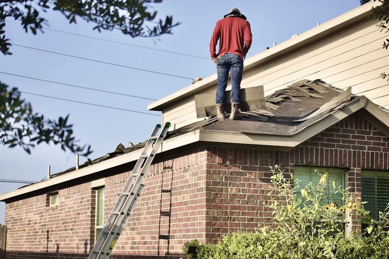 Professional roofer working on a residential roof in Sewaren